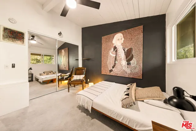 a living room with furniture and a painting on the wall