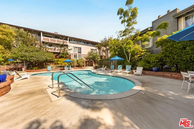 a swimming pool with outdoor seating and yard