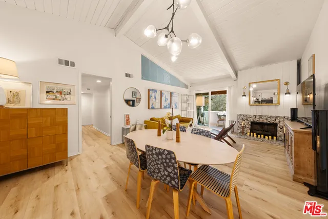 a dining room with furniture and wooden floor