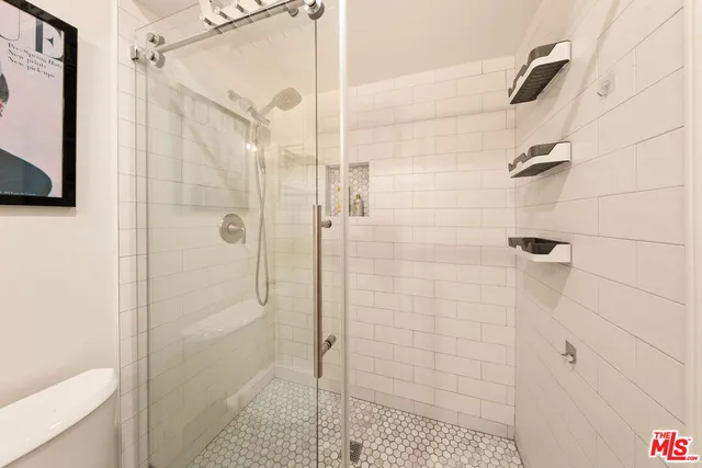 a bathroom with a shower and a toilet