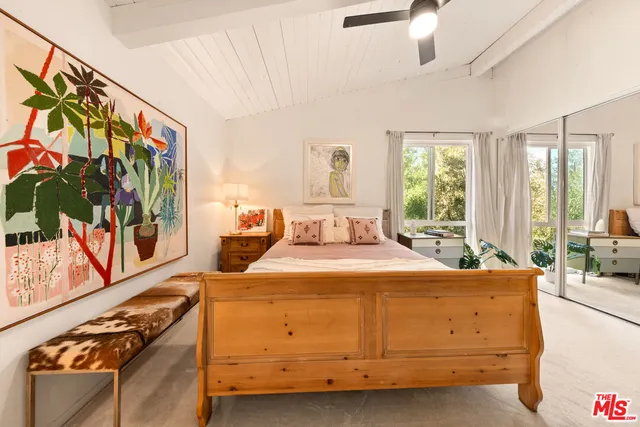 a room with a bed and a flat screen tv