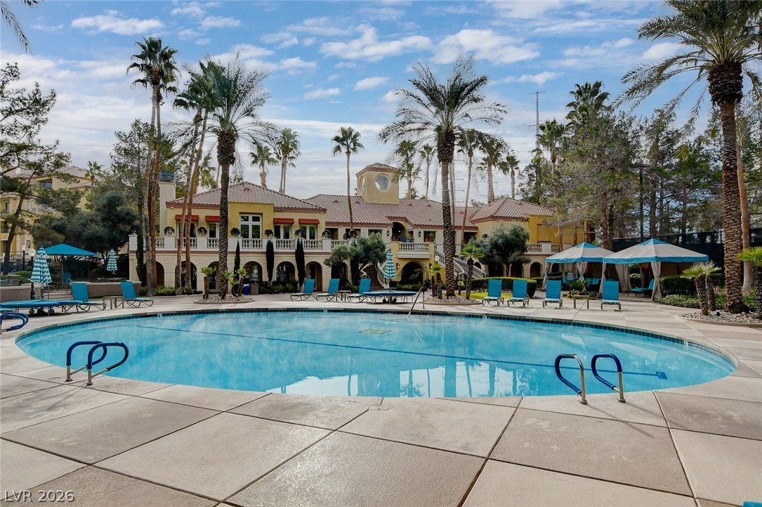 230 East Flamingo Road, Unit 106 Las Vegas, NV 89169 - Photo 44 of 66 A resort-style oasis offers a gleaming pool and inviting cabanas amidst lush palm landscaping.