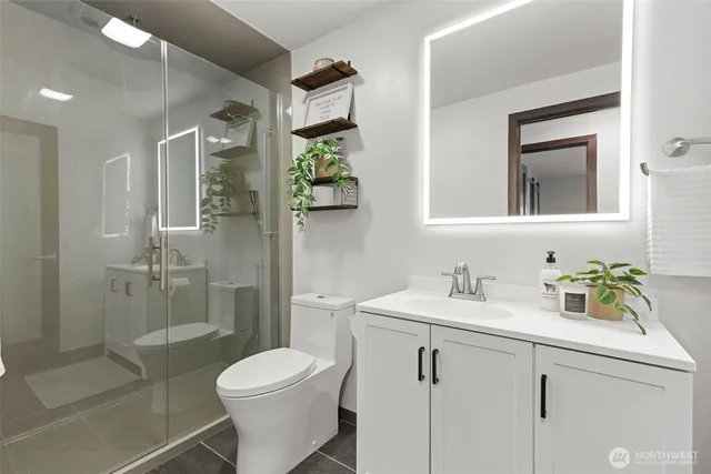 a bathroom with a sink toilet and shower