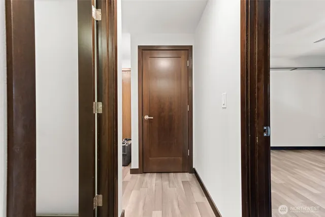 a view of a hallway with wooden floor