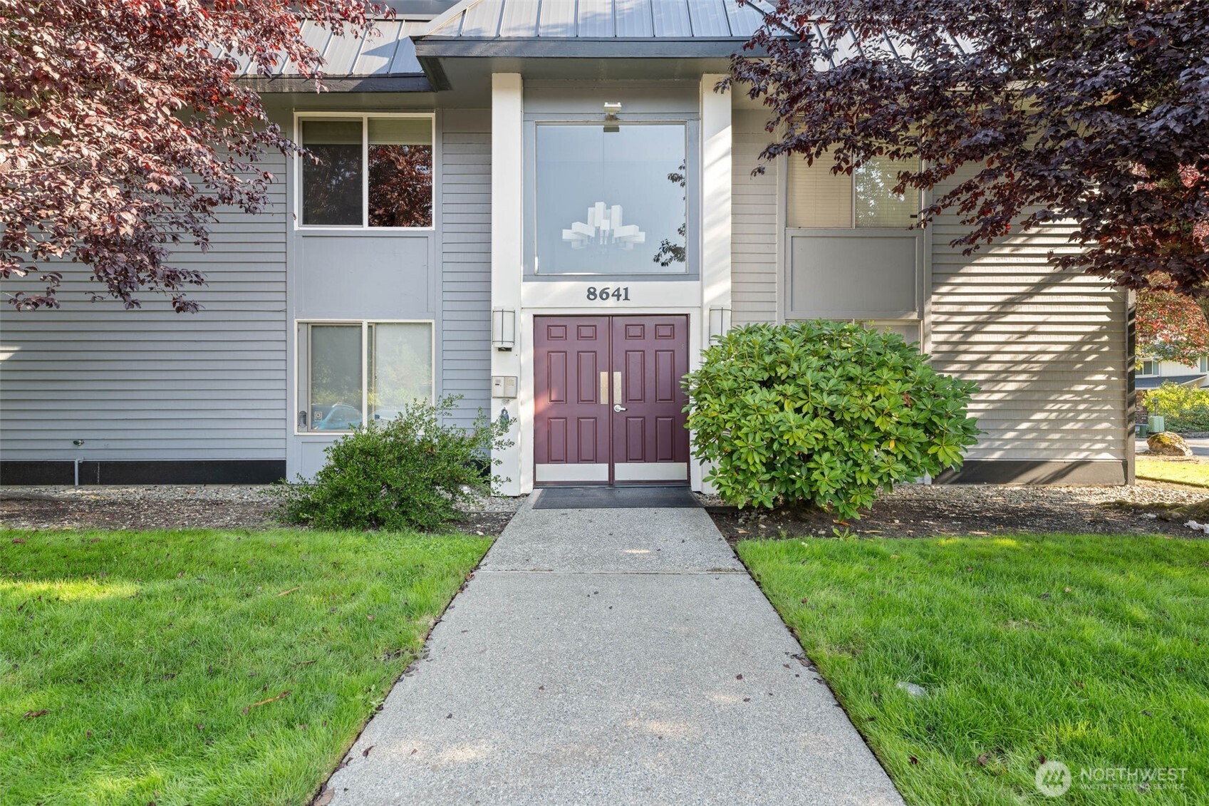 8641 Zircon Drive Southwest, Unit U3 Lakewood, WA 98498 - Photo 2 of 32 a front view of a house with garden