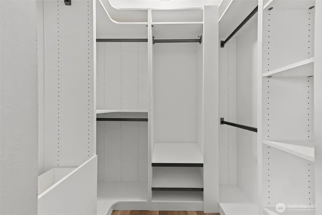 a view of walk in closet with empty racks