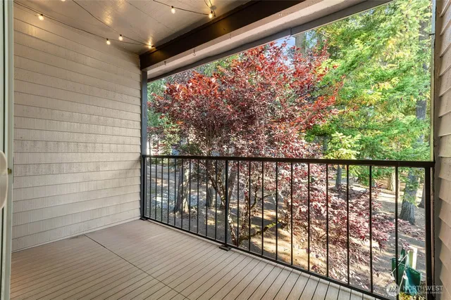 a balcony with furniture and a potted plant