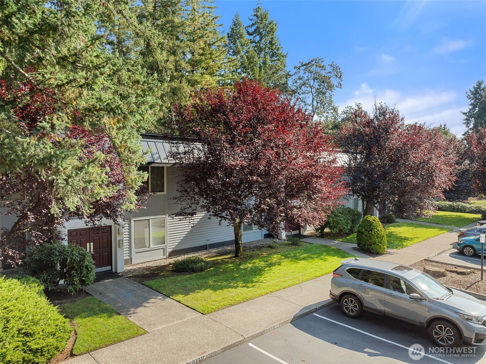 8641 Zircon Drive Southwest, Unit U3 Lakewood, WA 98498 - Photo 27 of 32 a car parked in front of a house with a yard