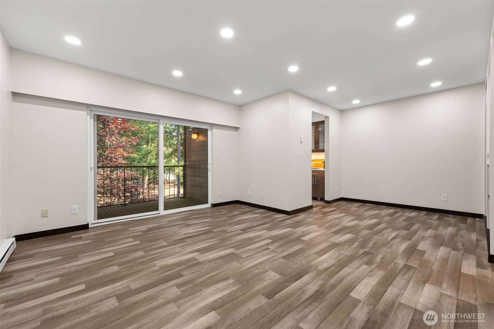 8641 Zircon Drive Southwest, Unit U3 Lakewood, WA 98498 - Photo 7 of 32 a view of an empty room with wooden floor and a window
