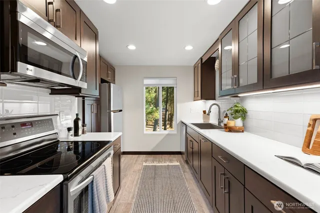 a kitchen with a sink stove and microwave