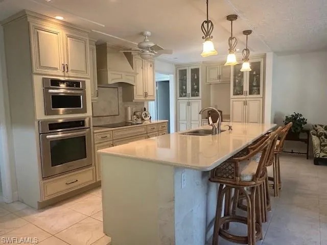 a large kitchen with a table and chairs