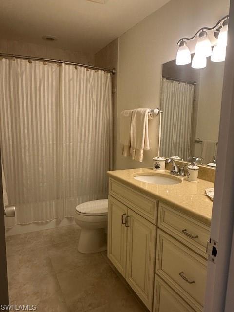 1261 Pine Ridge Road Naples, FL 34108 - Photo 10 of 13 a bathroom with a granite countertop sink a toilet and a mirror