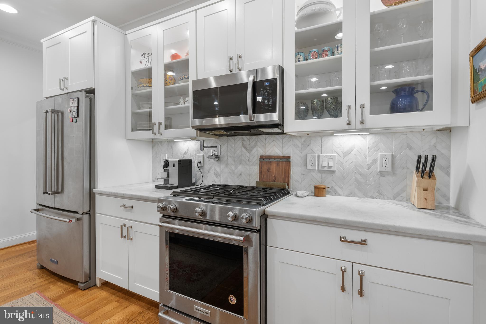 1428 Shepherd Street Northwest, Unit 1 Washington, DC 20011 - Photo 12 of 48 a kitchen with stainless steel appliances granite countertop a refrigerator sink and stove