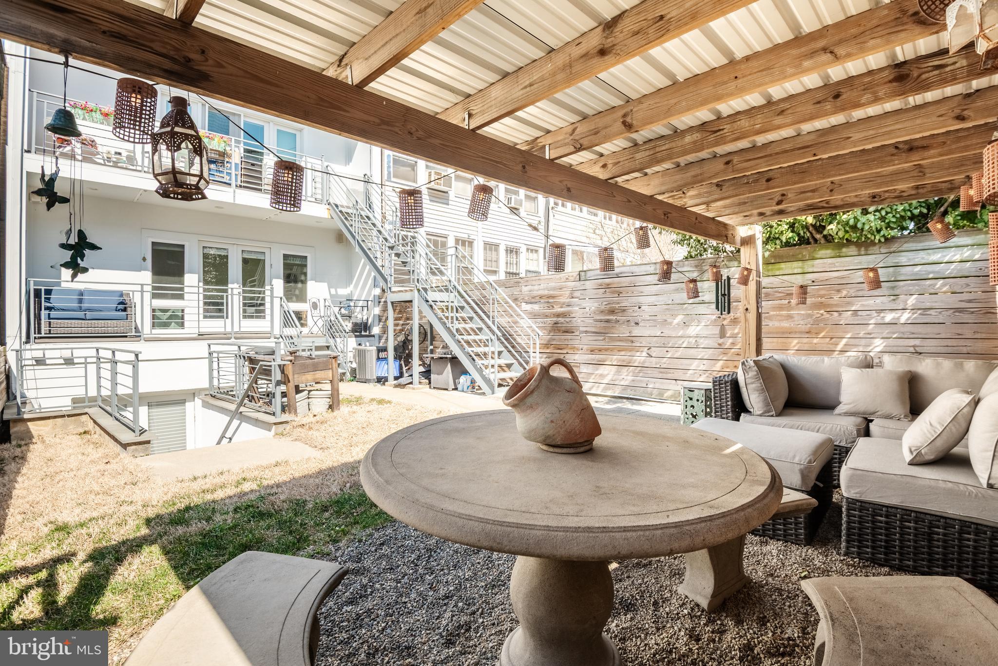 1428 Shepherd Street Northwest, Unit 1 Washington, DC 20011 - Photo 38 of 48 a view of a patio with couches table and chairs and potted plants