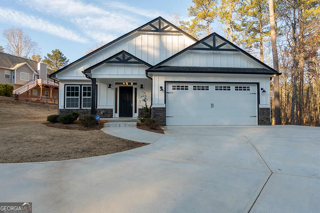 a view of a house with a yard and garage