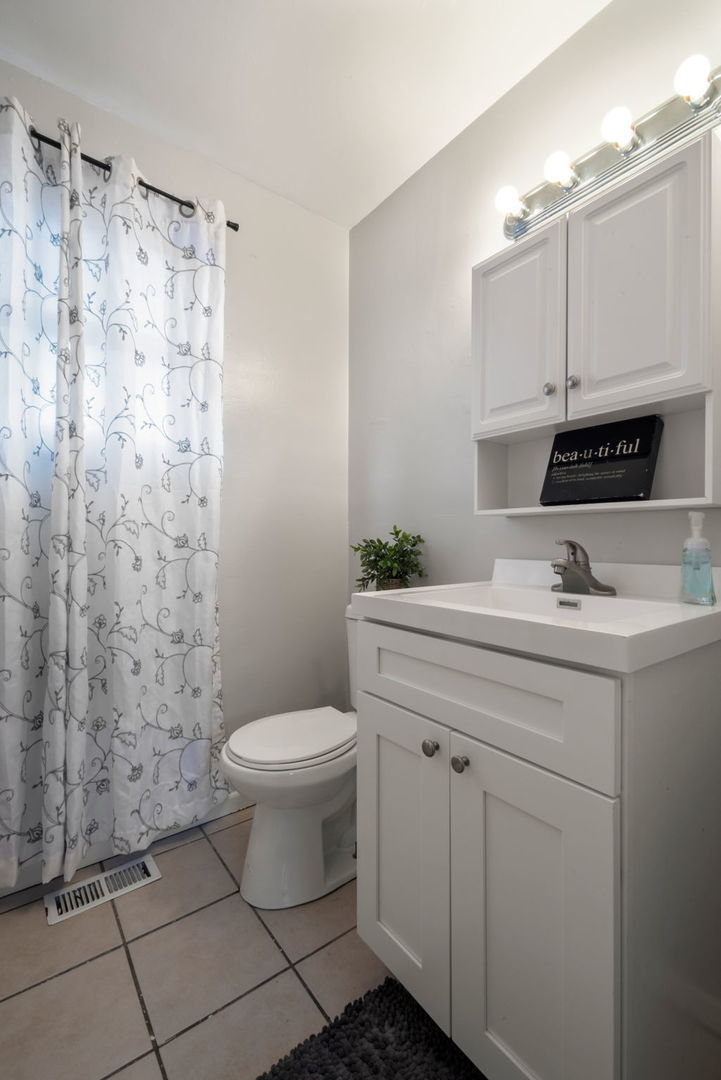 2102 West 73rd Street Chicago, IL 60636 - Photo 12 of 20 a bathroom with a sink toilet and shower