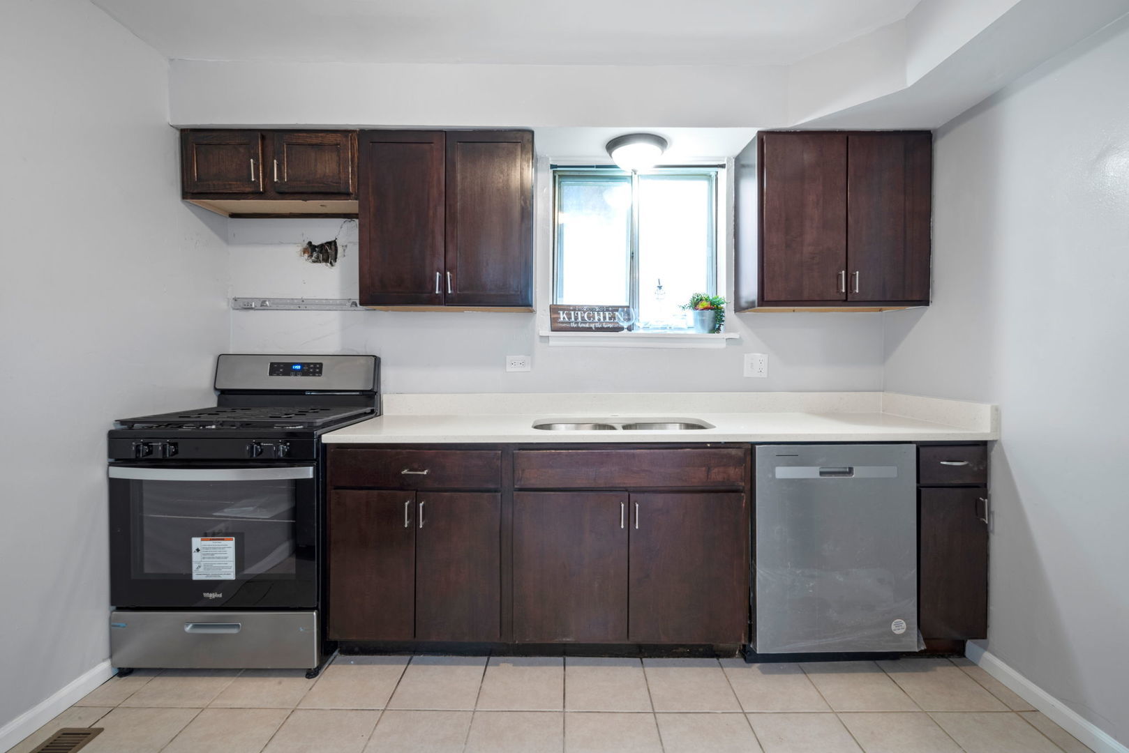 2102 West 73rd Street Chicago, IL 60636 - Photo 8 of 20 a kitchen with stainless steel appliances granite countertop a stove and a sink