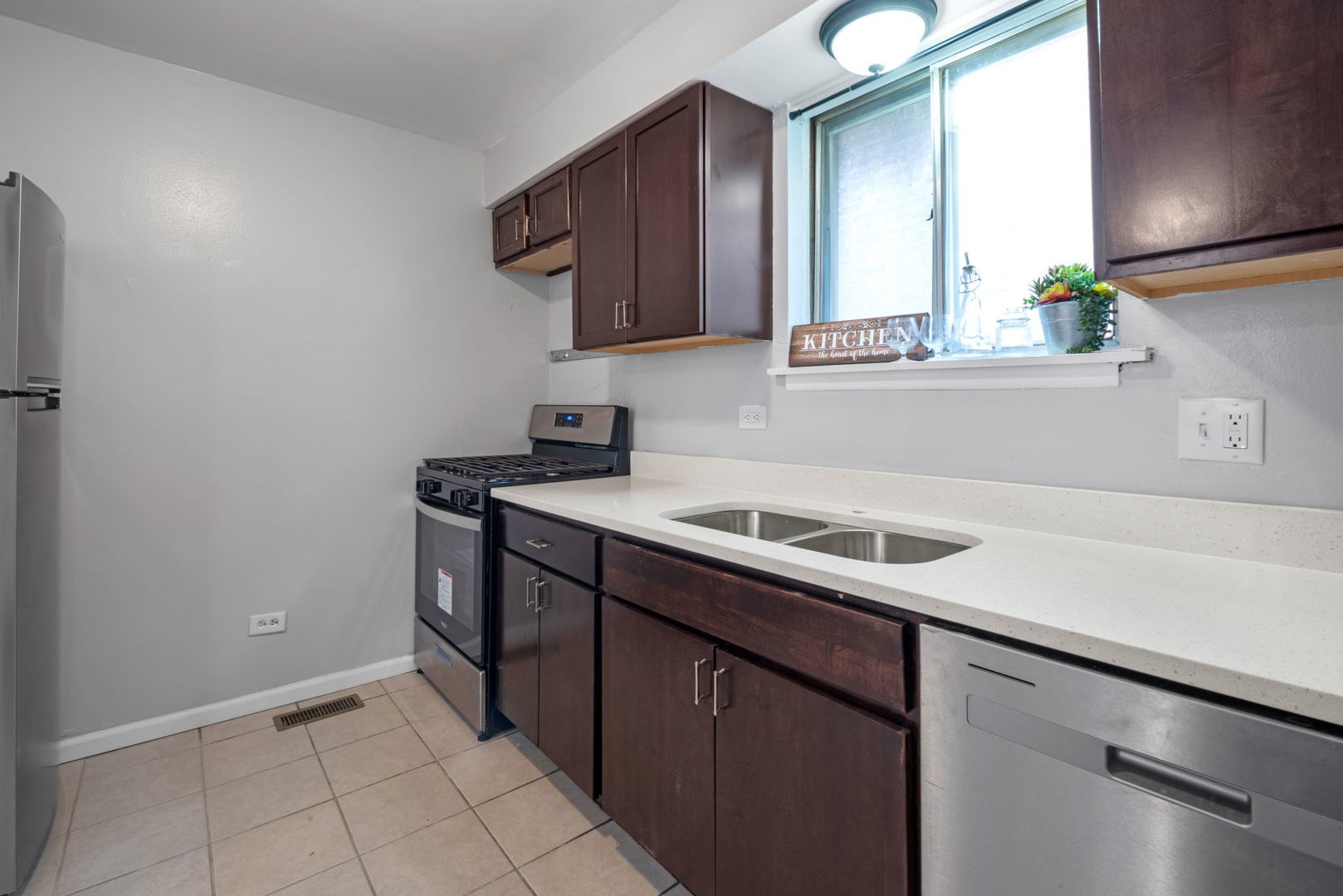 2102 West 73rd Street Chicago, IL 60636 - Photo 9 of 20 a kitchen with a sink and cabinets