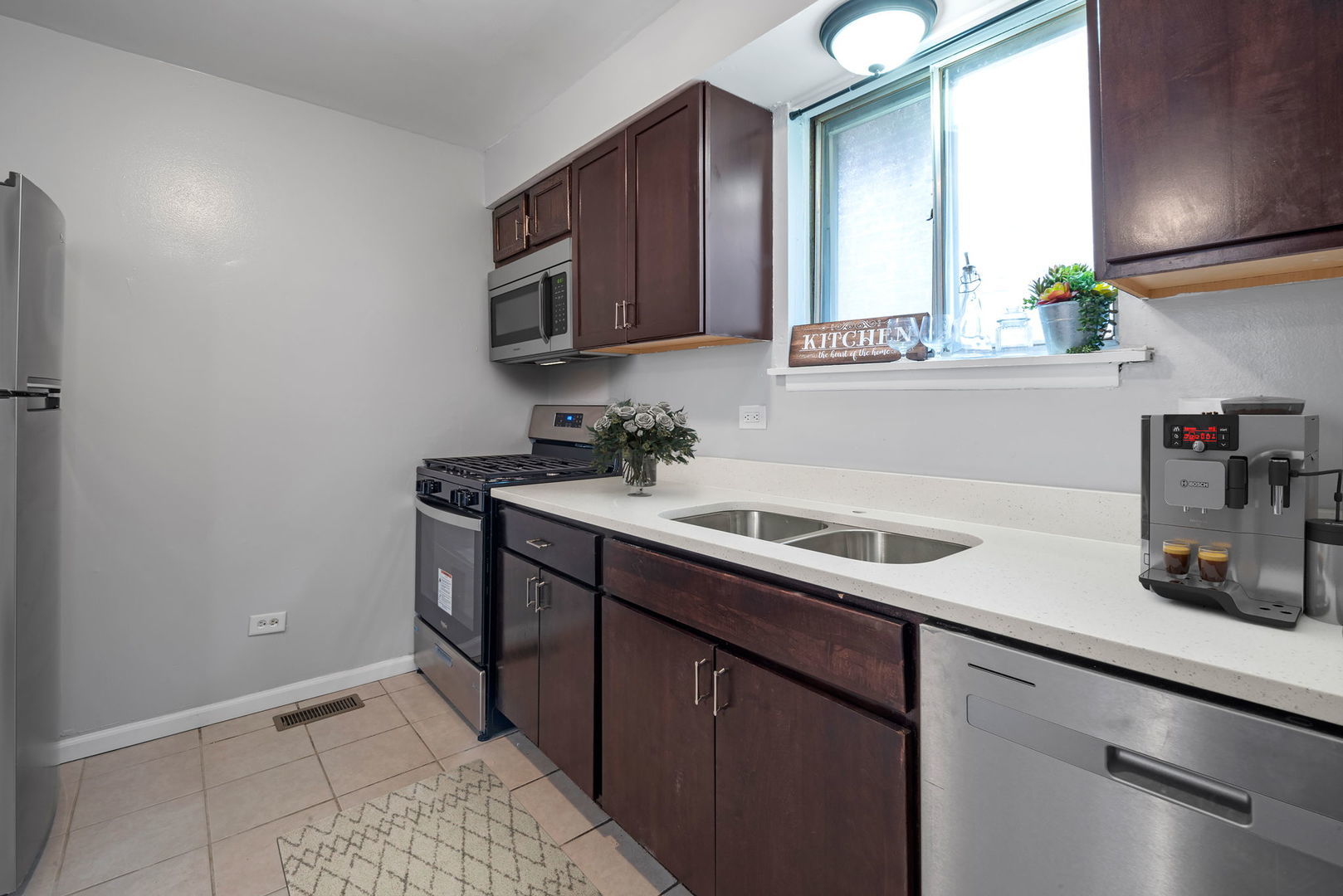 2102 West 73rd Street Chicago, IL 60636 - Photo 10 of 20 a kitchen with a sink and cabinets