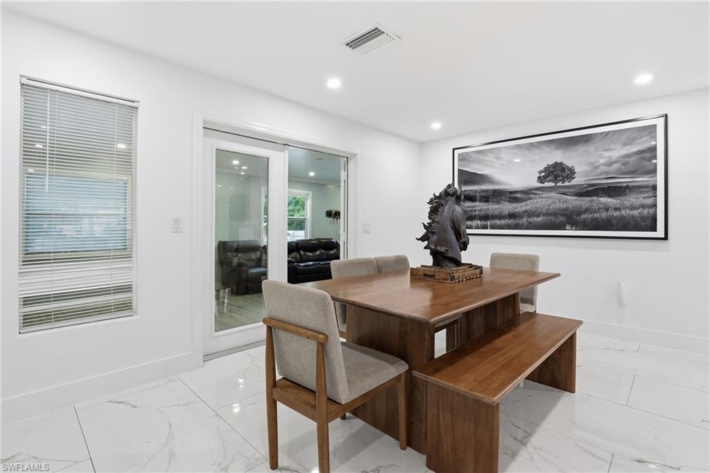 6005 Star Grass Lane Naples, FL 34116 - Photo 12 of 44 Dining room with recessed lighting and light marble finish floors