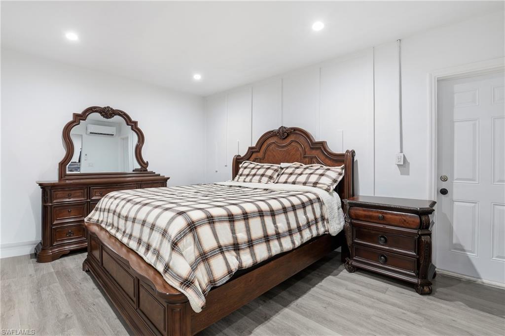 6005 Star Grass Lane Naples, FL 34116 - Photo 20 of 44 Bedroom with light wood-style floors, recessed lighting, and a mini split for heating / cooling