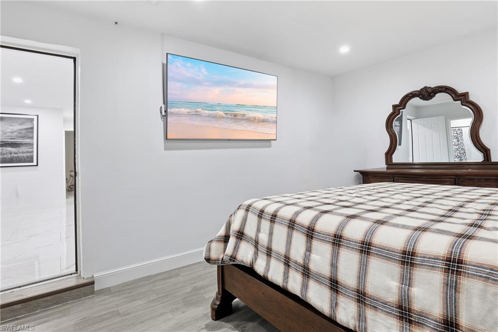 6005 Star Grass Lane Naples, FL 34116 - Photo 22 of 44 Bedroom with recessed lighting and light wood-style floors
