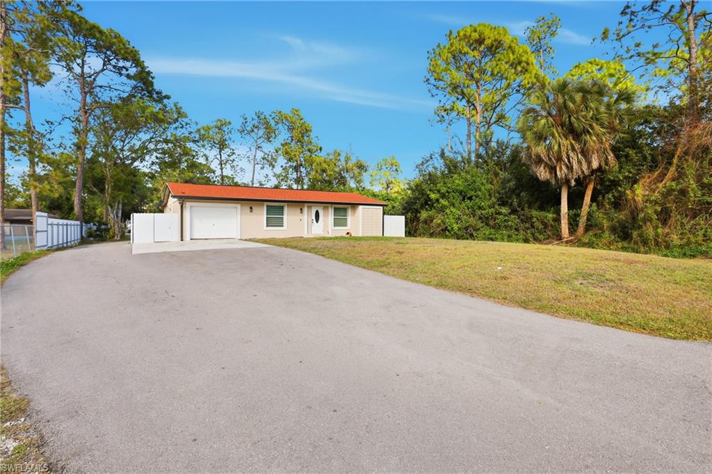 6005 Star Grass Lane Naples, FL 34116 - Photo 4 of 44 Single story home with driveway and a garage