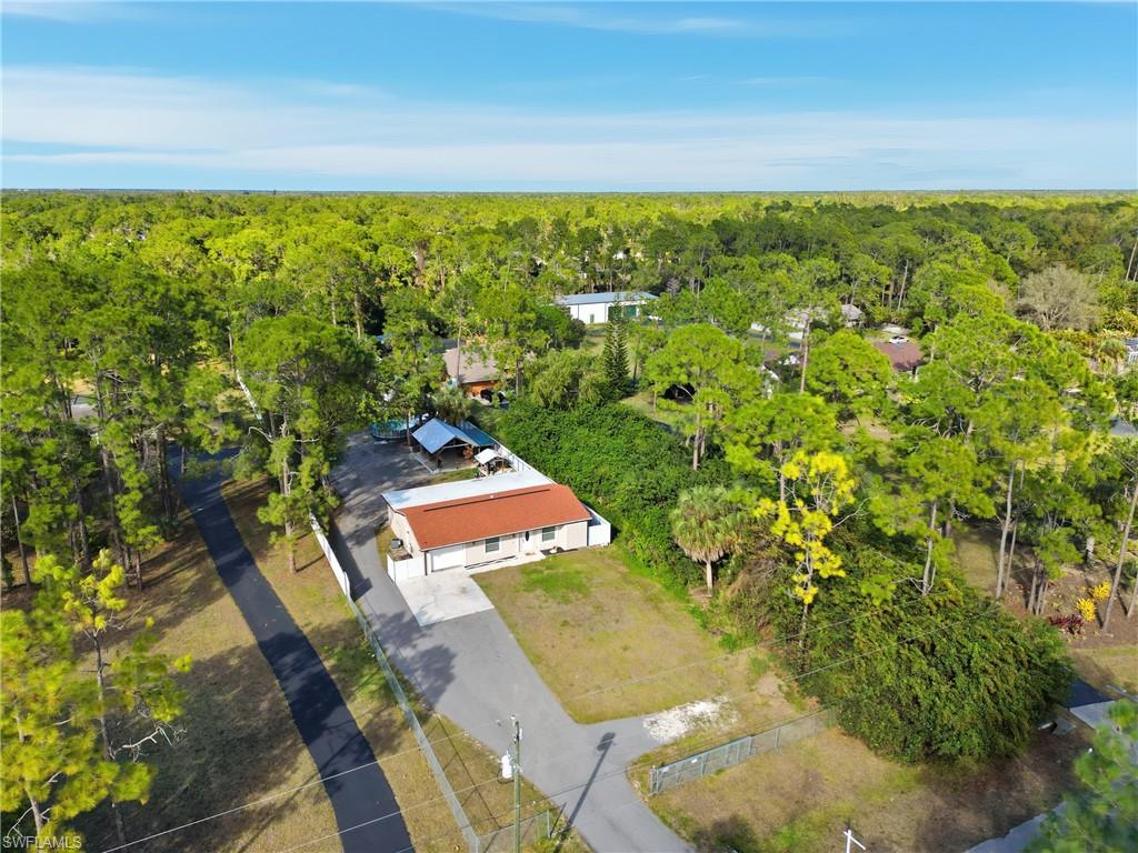 6005 Star Grass Lane Naples, FL 34116 - Photo 41 of 44 Aerial view of property and surrounding area featuring a forest