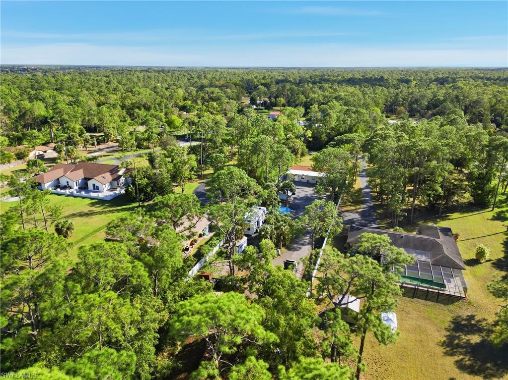 6005 Star Grass Lane Naples, FL 34116 - Photo 44 of 44 Aerial perspective of suburban area with a forest