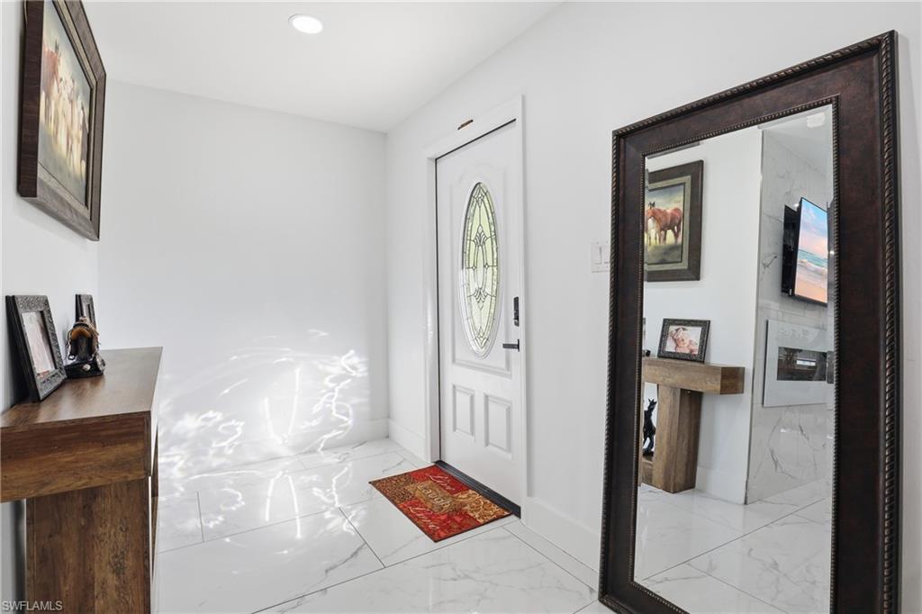 6005 Star Grass Lane Naples, FL 34116 - Photo 5 of 44 Entrance foyer with light marble finish floors and recessed lighting
