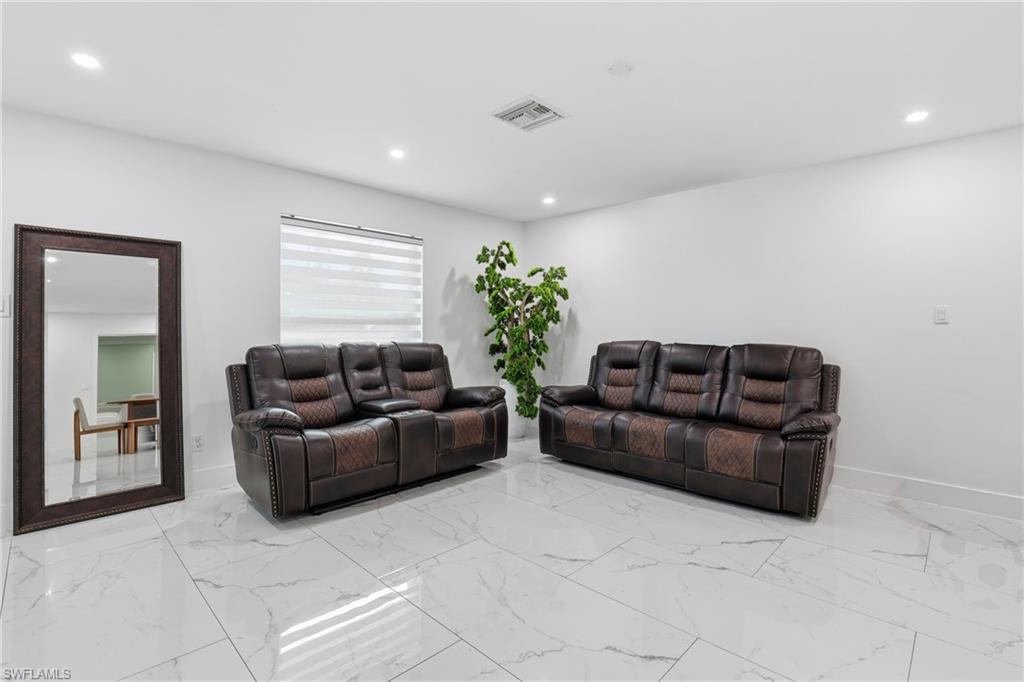 6005 Star Grass Lane Naples, FL 34116 - Photo 6 of 44 Living area featuring recessed lighting and light marble finish flooring