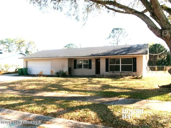 a view of a house with a yard and sitting area
