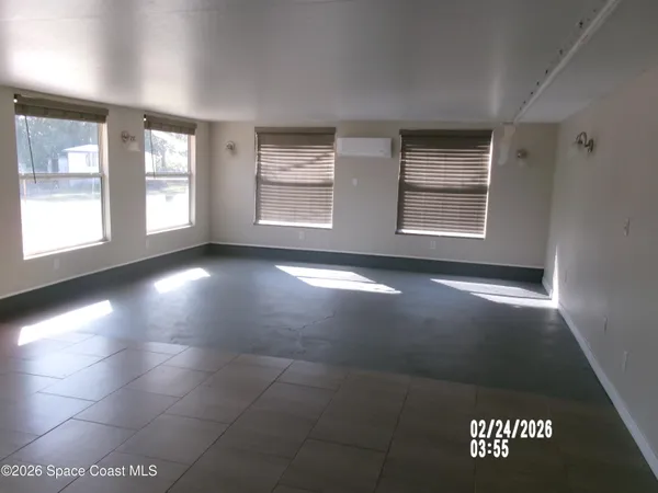 a view of an empty room with windows