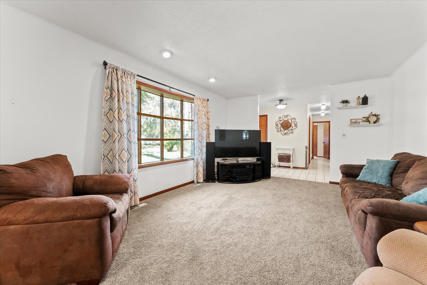 1108 Riverside Court Mahomet, IL 61853 - Photo 6 of 50 a living room with furniture and a flat screen tv