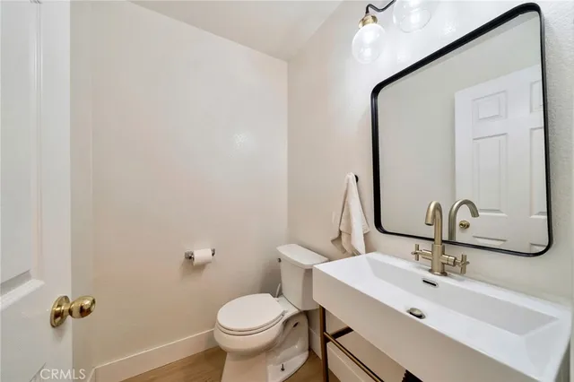 a bathroom with a sink a toilet and a mirror