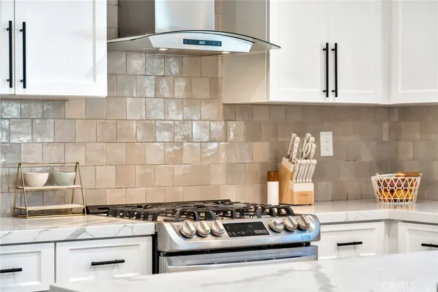 a white stove top oven sitting inside of a kitchen