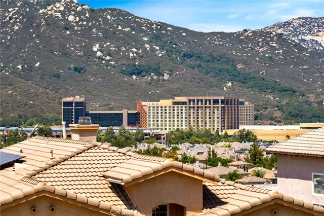 a view of a patio with table and chairs under an umbrella with a small yard