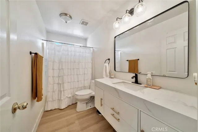 a bedroom with a bed and a painting on the wall