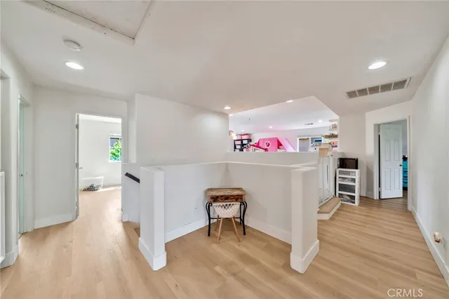 a bedroom with a bed and a wooden floor