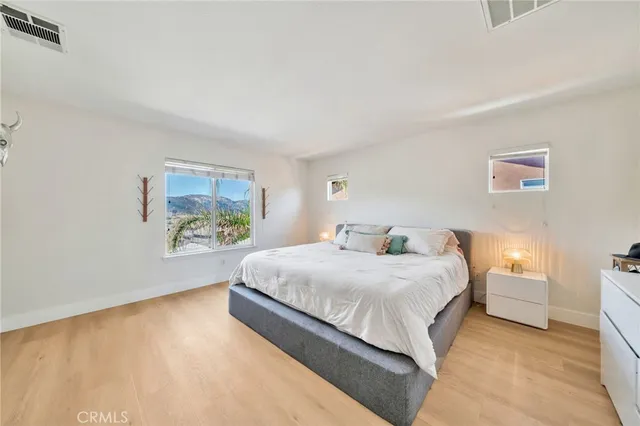 a spacious bedroom with a bed and a cabinets