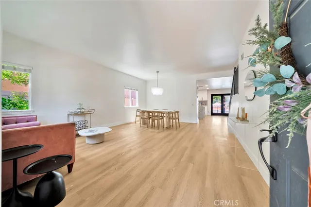 a dining room with furniture and wooden floor