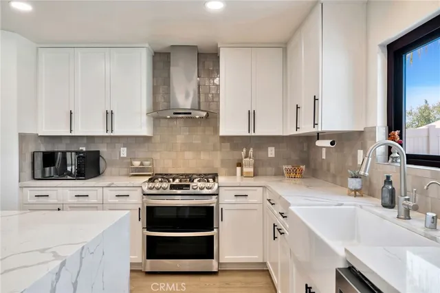 a kitchen with cabinets appliances a sink and a counter top space