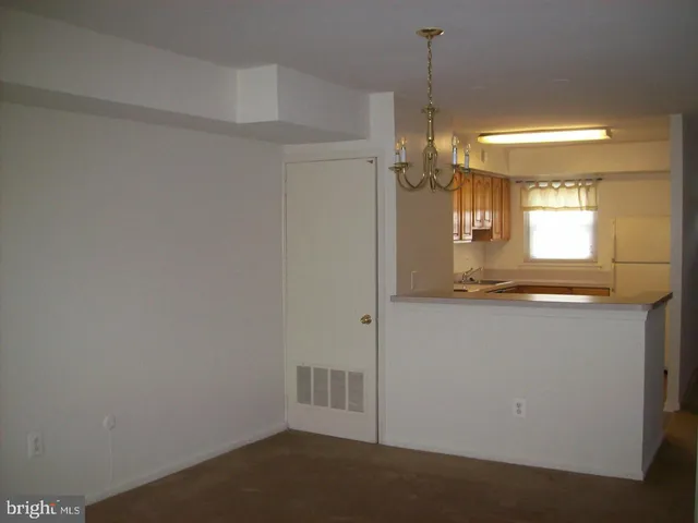 a view of a kitchen from the hallway
