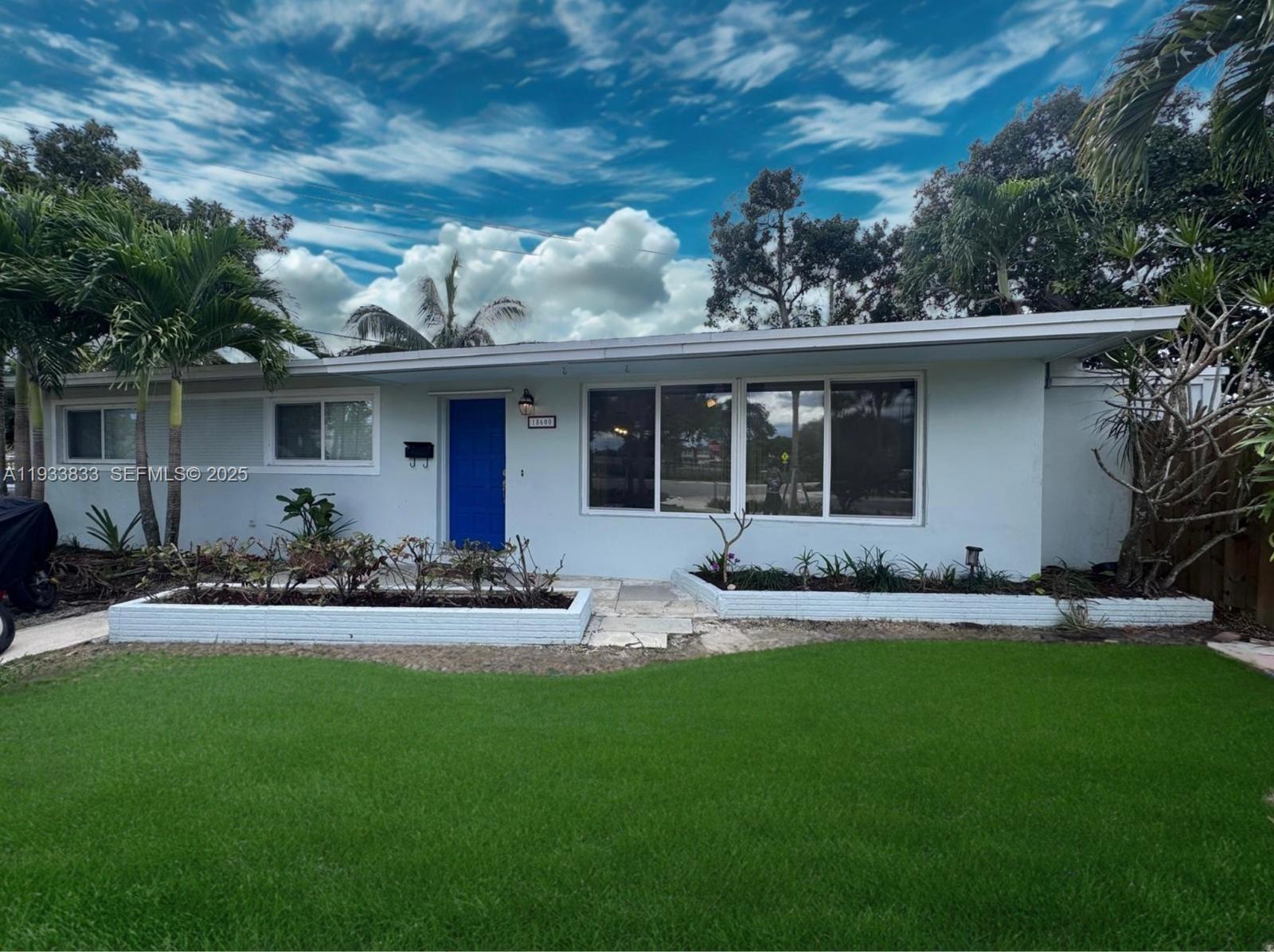 18600 Southwest 97th Avenue Cutler Bay, FL 33157 - Photo 1 of 23 a front view of house with yard and green space