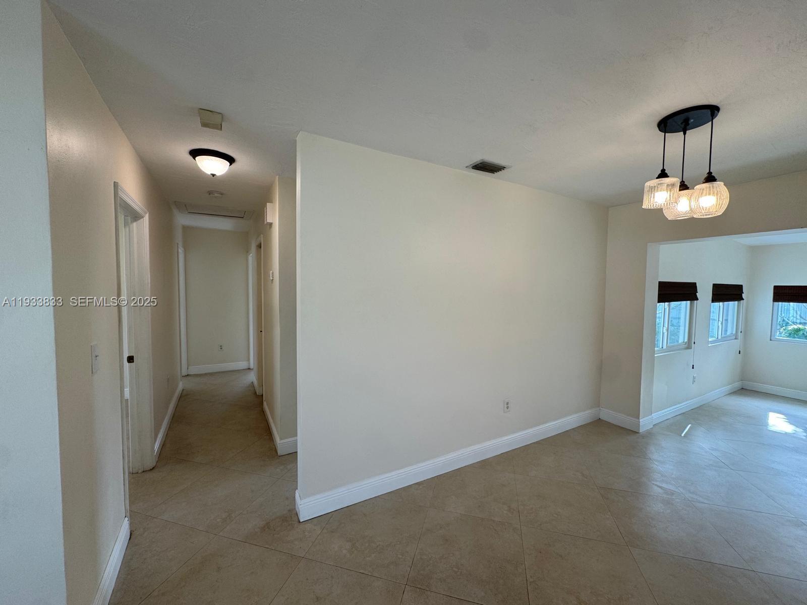 18600 Southwest 97th Avenue Cutler Bay, FL 33157 - Photo 7 of 23 a view of a hallway with chandelier