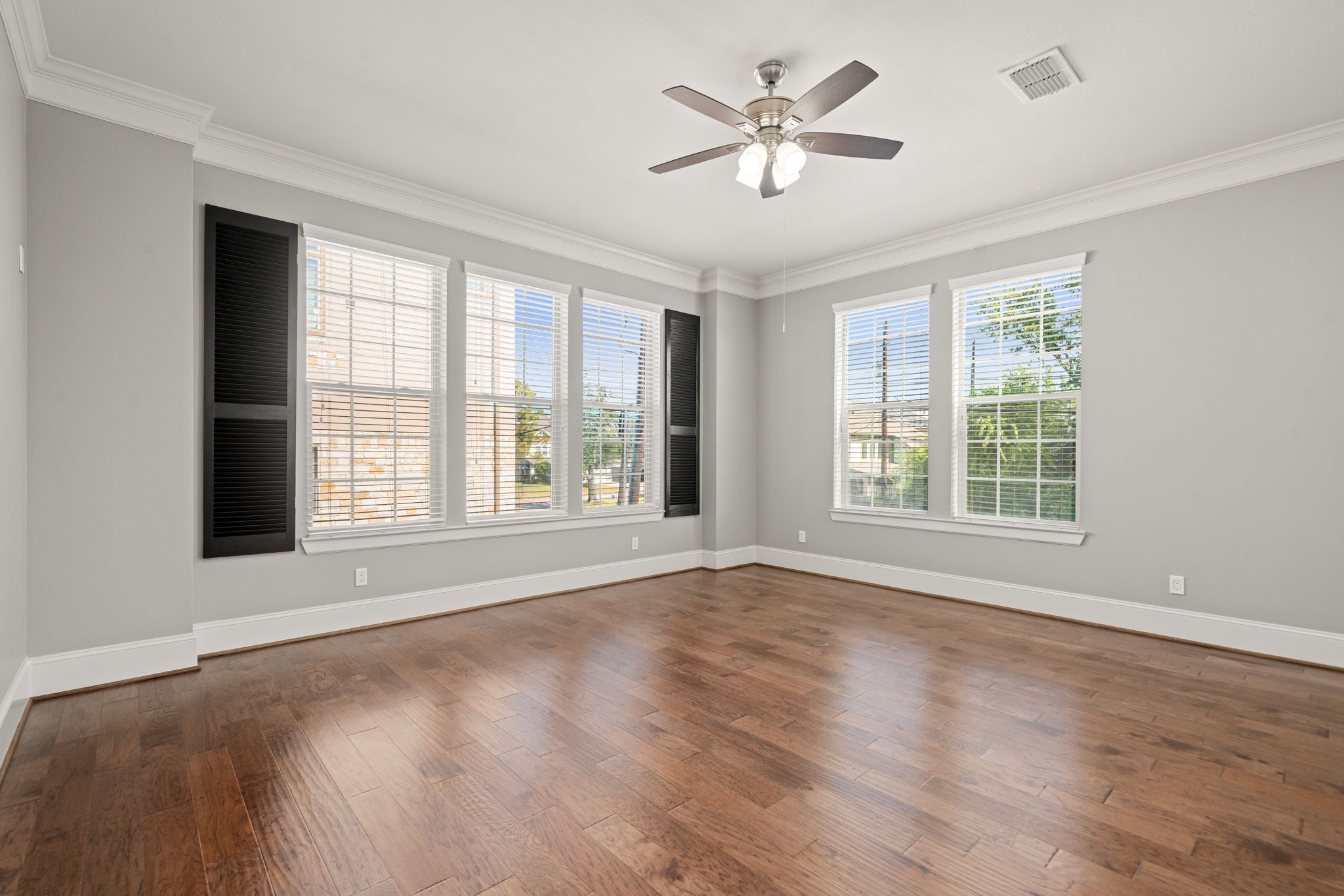 6703 Highclere Manor Lane Houston, TX 77055 - Photo 11 of 36 a view of an empty room with a window and wooden floor