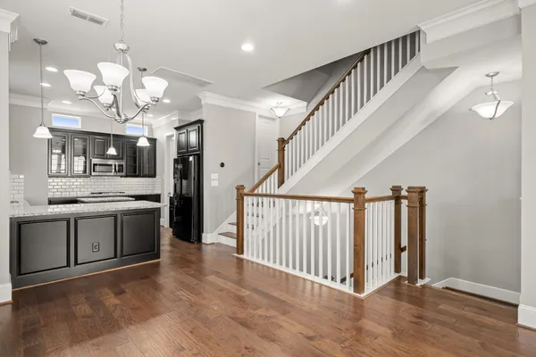 a large kitchen with kitchen island a large counter top space stainless steel appliances and a window