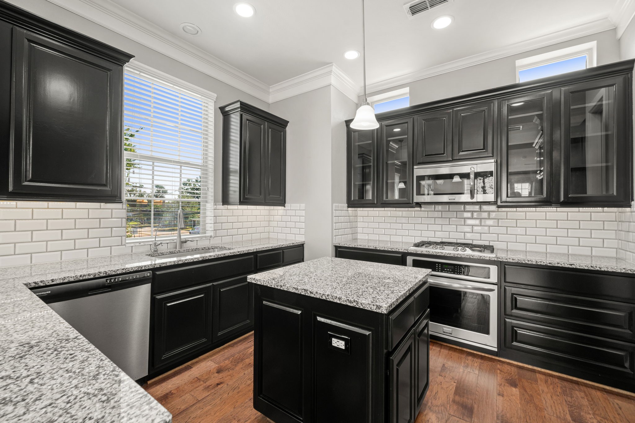 6703 Highclere Manor Lane Houston, TX 77055 - Photo 18 of 36 a kitchen with a sink and stove