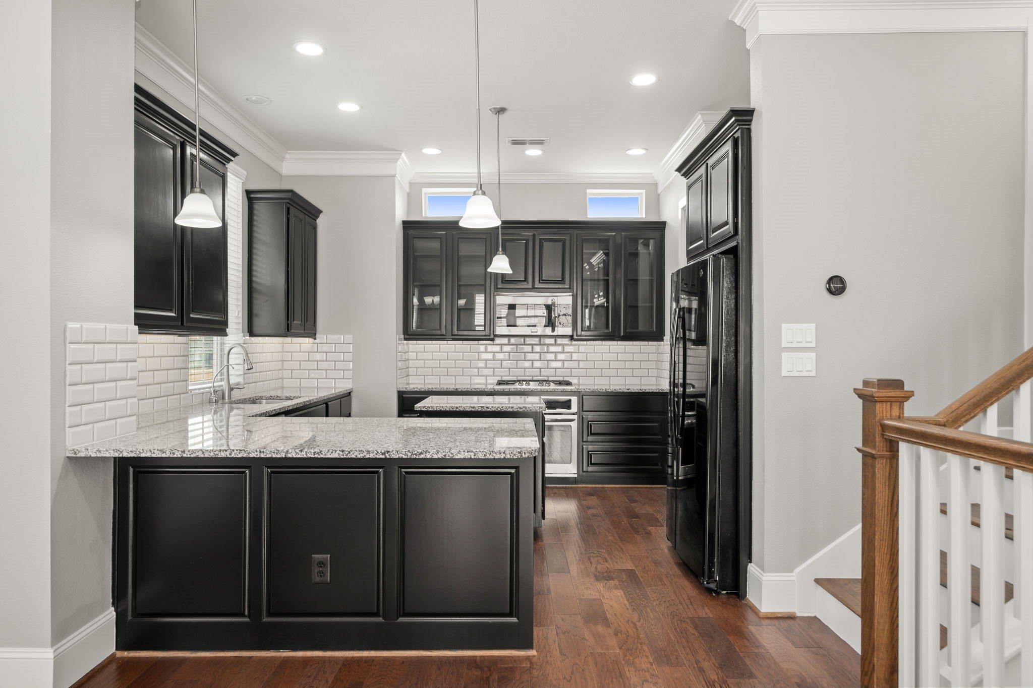 6703 Highclere Manor Lane Houston, TX 77055 - Photo 20 of 36 a kitchen with stainless steel appliances granite countertop a sink a stove and a refrigerator