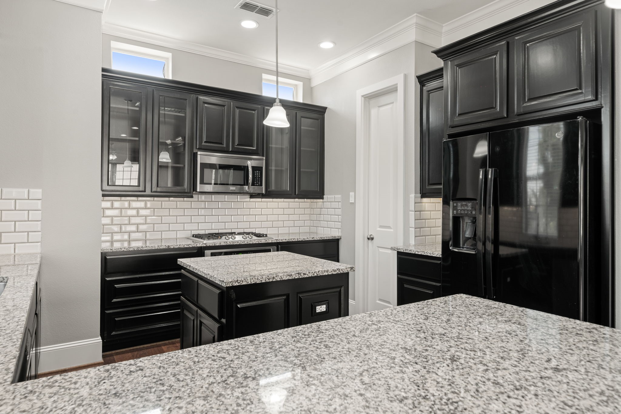 6703 Highclere Manor Lane Houston, TX 77055 - Photo 21 of 36 a kitchen with granite countertop stainless steel appliances and wooden cabinets